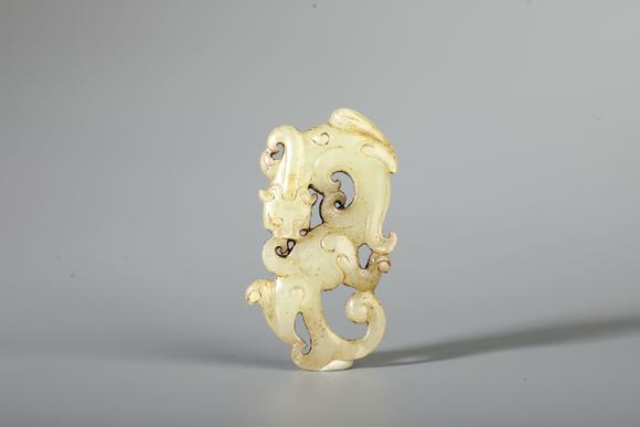 SEAVIEW AUCTIONS PTY LTDA Pale White Jade Openwork Coiled Dragon Pendant, China, 2nd BCE–2nd CE