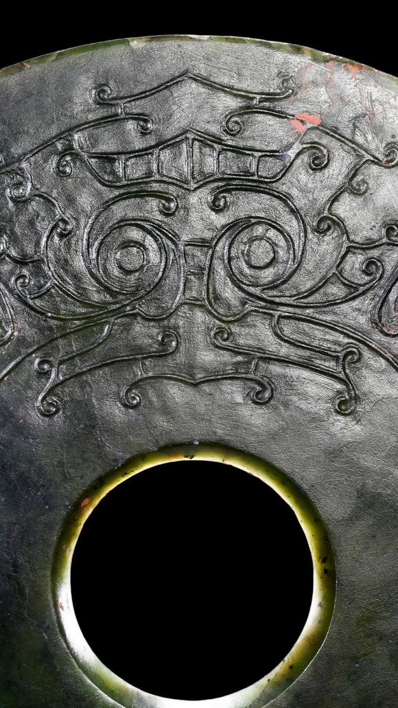 Castle AuctionA Dark Green Jade Bi Disc with Incised Decoration, Neolithic, Circa 3300–2300 C BC Pr.