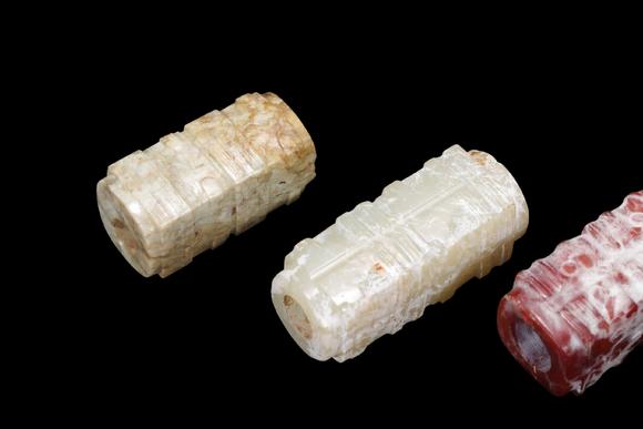 Castle AuctionA Group of Six Calcified & Reddish Jade Cong-Style Beads, Liangzhu, Circa 3300–2300 C BC Pr.