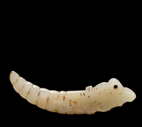 Castle AuctionA White Jade Silkworm Pendant with Russet Veins, Western Zhou, Circa 10th–8th C BC Pr.