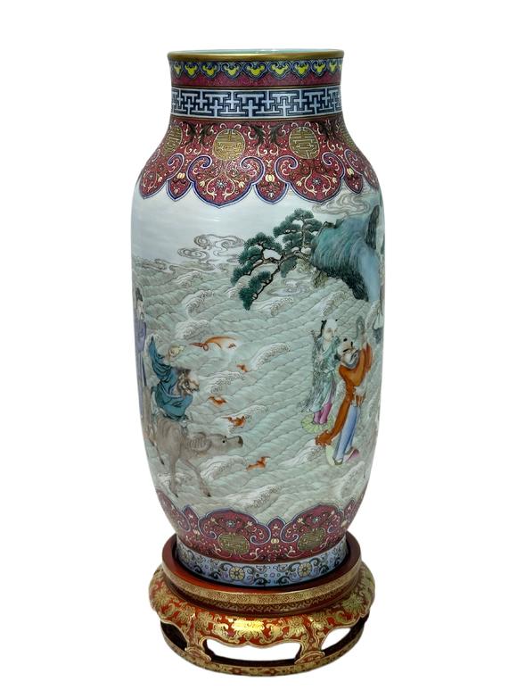 Castle AuctionA Chinese Rouge Famille Rose vase adorned with the Eight Immortals' figures pattern, together with A Chinese porcelain stand, Qian Long Pr. 