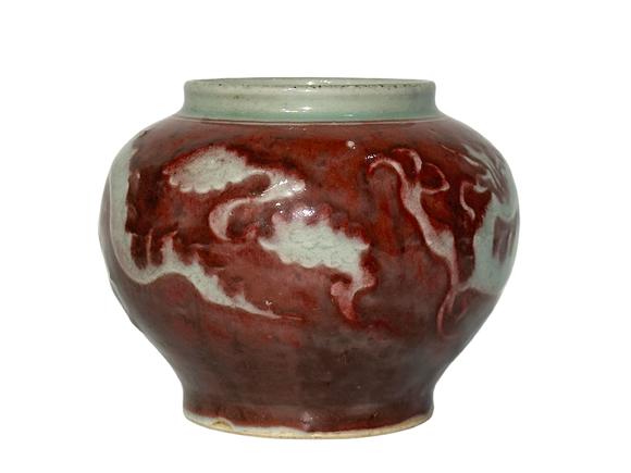 Castle AuctionThe underglaze red jar with hidden dragon pattern carvings, Ming Dynasty Pr. or earlier.