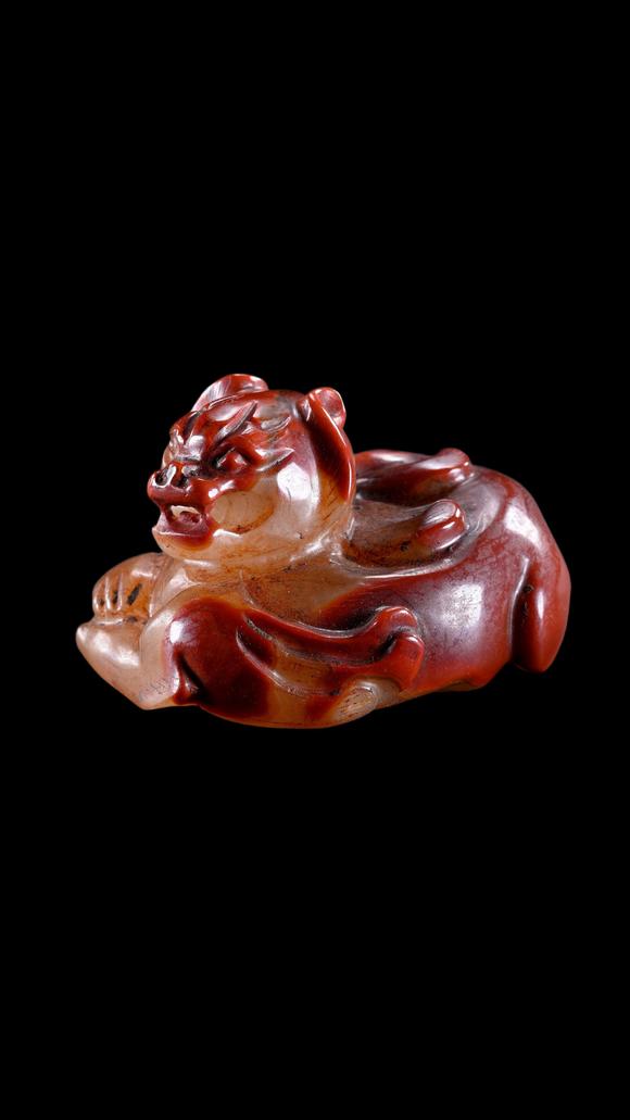 Castle AuctionA Reddish Jade Mythical Beast Carving, Han, Circa 2nd C BC–2nd C AD Pr.
