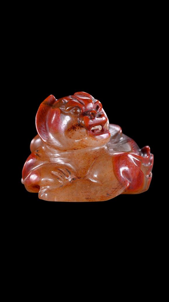 Castle AuctionA Reddish Jade Mythical Beast Carving, Han, Circa 2nd C BC–2nd C AD Pr.