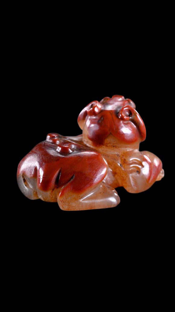 Castle AuctionA Reddish Jade Mythical Beast Carving, Han, Circa 2nd C BC–2nd C AD Pr.