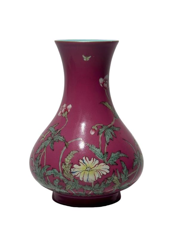 Castle AuctionA Chinese rouge-red ground famille rose vase, Qian Long Pr. 