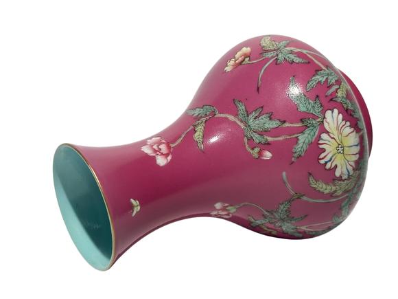 Castle AuctionA Chinese rouge-red ground famille rose vase, Qian Long Pr. 