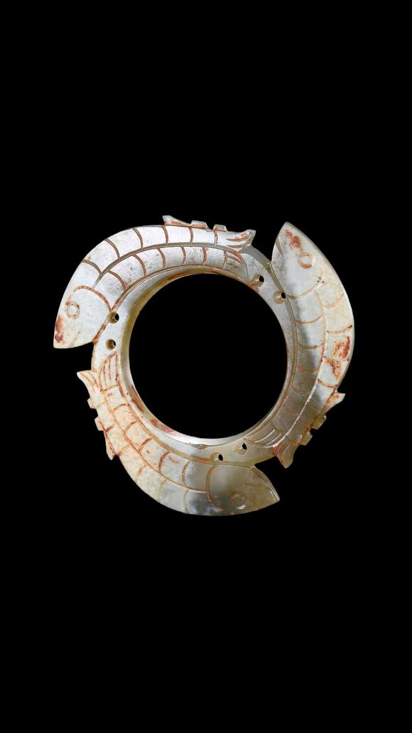 Castle AuctionA Pale Jade Dragon-Ring Pendant with Red Pigment Traces, Han, Circa 2nd C BC–2nd C AD Pr.