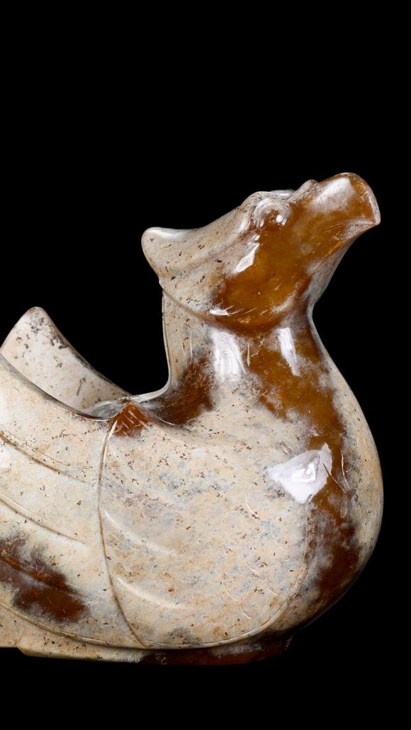 Castle AuctionA Calcified White Jade Phoenix Carving with Russet Inclusions, Han, Circa 2nd C BC–2nd C AD Pr.