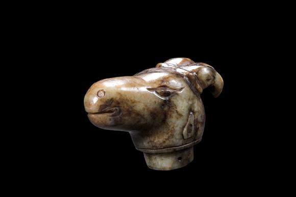 Castle AuctionA Mottled Pale Jade Ram Head Cane Finial, Han, Circa 2nd C BC–2nd C AD Pr.