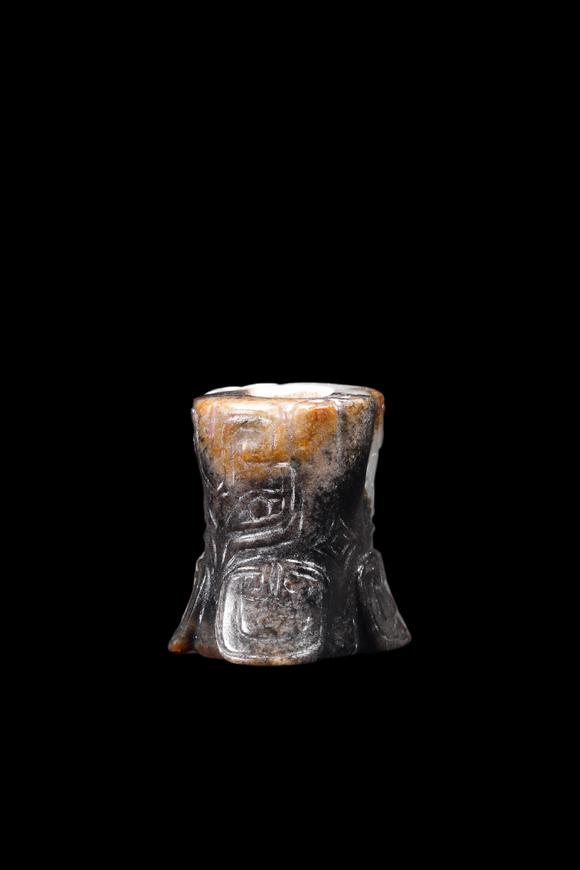Castle AuctionA Mottled Black & Brown Jade Flared Taotie Bead, Shang, Circa 13th–11th C BC Pr.