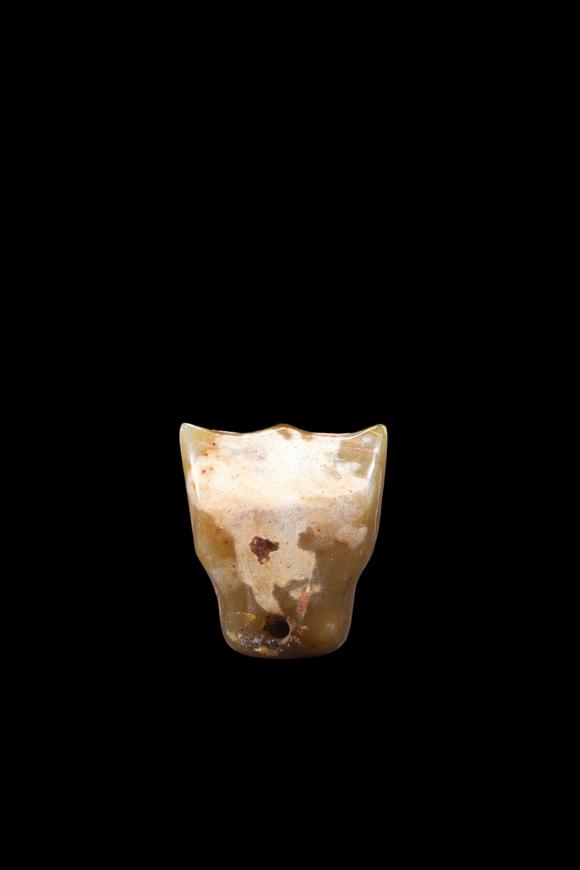 Castle AuctionA Calcified Yellow Jade Tooth-Form Pendant, Shang, Circa 13th–11th C BC Pr.