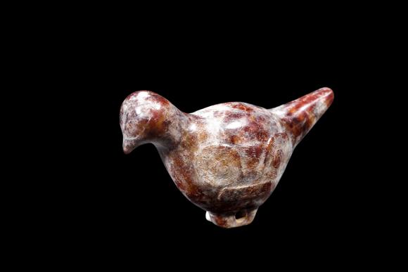Castle AuctionA Mottled Reddish Brown Jade Bird Carving, Liangzhu, Circa 3300–2300 C BC Pr.
