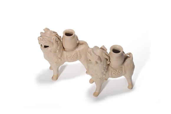 Castle AuctionA Pair of White Porcelain Lion Vase Ornaments, 7th–10th C Pr.