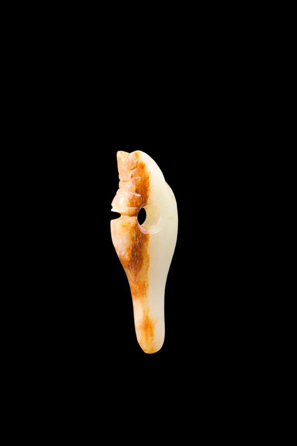 Castle AuctionA Pale Jade Dragon Tooth Pendant with Russet Inclusions, Shang, Circa 13th–11th C BC Pr.