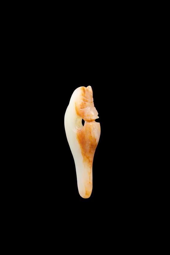 Castle AuctionA Pale Jade Dragon Tooth Pendant with Russet Inclusions, Shang, Circa 13th–11th C BC Pr.