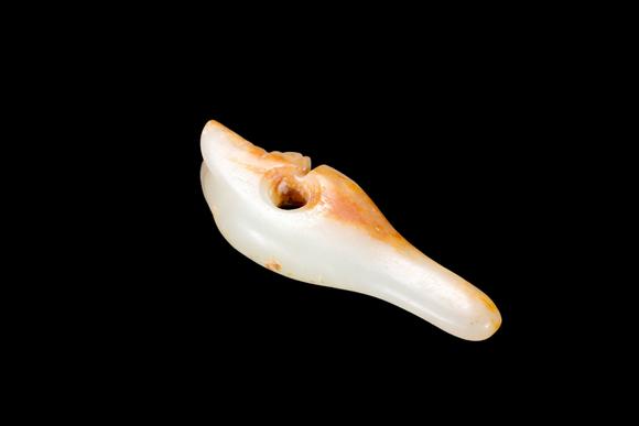 Castle AuctionA Pale Jade Dragon Tooth Pendant with Russet Inclusions, Shang, Circa 13th–11th C BC Pr.