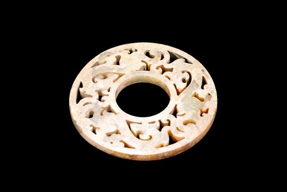 Castle AuctionA Calcified Yellow Jade Openwork Dragon Bi Disc, Han, Circa 2nd C BC–2nd C AD Pr.