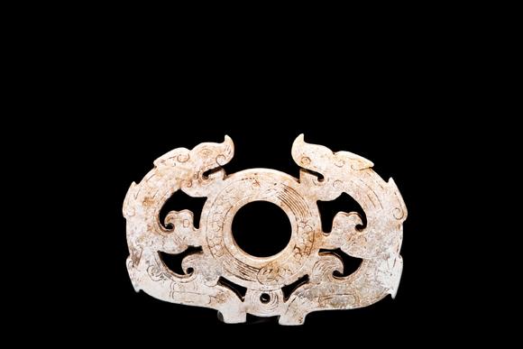 Castle AuctionA Calcified Pale Jade Twin Dragon Openwork Pendant, Han, Circa 2nd C BC–2nd C AD Pr.