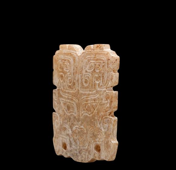 Castle AuctionA Calcified Brown Jade Taotie Mask Pendant, Western Zhou, Circa 10th–9th C BC Pr.