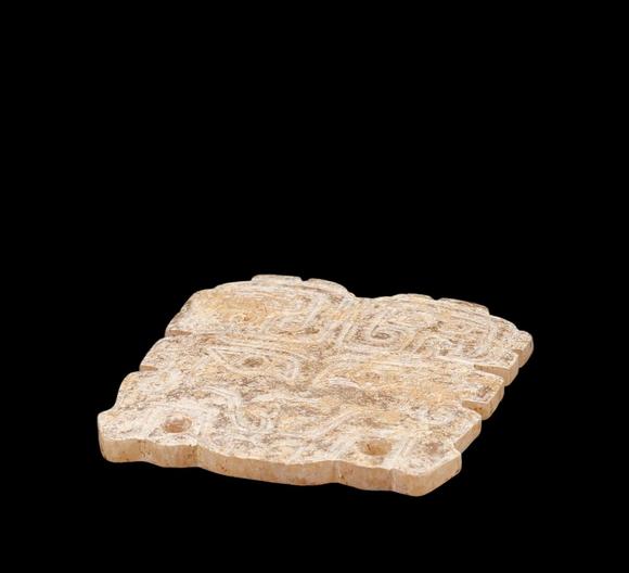 Castle AuctionA Calcified Brown Jade Taotie Mask Pendant, Western Zhou, Circa 10th–9th C BC Pr.