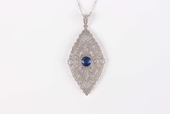 TooveysA platinum, treated sapphire and diamond marquise shaped pendant, collet set with the circular cut sapphire at the centre, length 4.3cm, with a platin