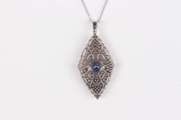 TooveysA platinum, treated sapphire and diamond marquise shaped pendant, collet set with the circular cut sapphire at the centre, length 4.3cm, with a platin