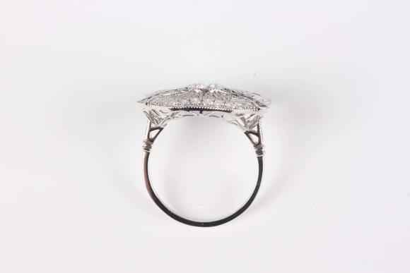 TooveysA platinum, sapphire and diamond ring, collet set with the principal circular cut diamond at the centre, otherwise in a pierced millegrain design, det