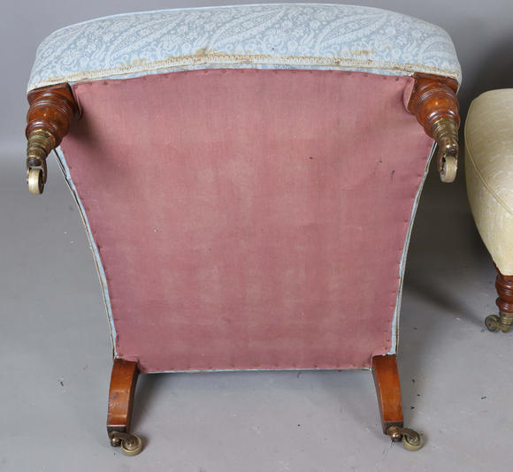 TooveysA near pair of late Victorian Howard & Sons armchairs, each buttoned back above scroll arms, on turned walnut legs with gilt brass caps and castors, e