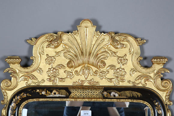 TooveysAn impressive pair of early 20th century Queen Anne style gilt and black japanned pier mirrors, each shaped crest with central shell and griffon heads