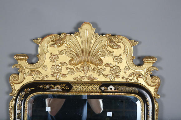 TooveysAn impressive pair of early 20th century Queen Anne style gilt and black japanned pier mirrors, each shaped crest with central shell and griffon heads