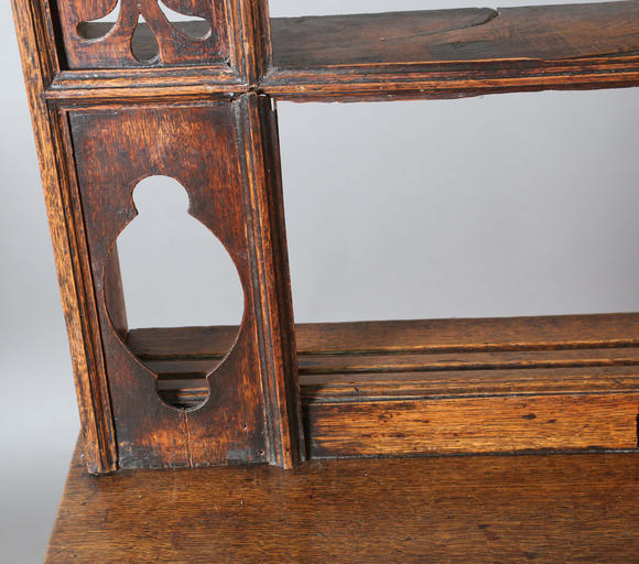 TooveysA good George III North Country oak dresser, the plate rack with pierced side panels above a lappet carved frieze and an arrangement of nine drawers,