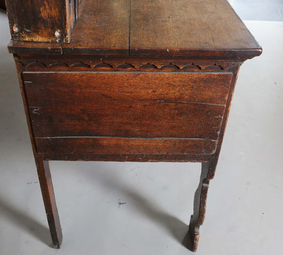 TooveysA good George III North Country oak dresser, the plate rack with pierced side panels above a lappet carved frieze and an arrangement of nine drawers,