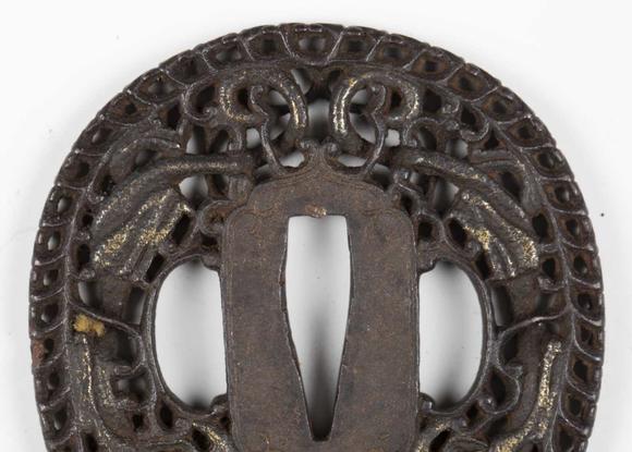 TooveysA fine Japanese oval iron tsuba, Edo period, with intricate