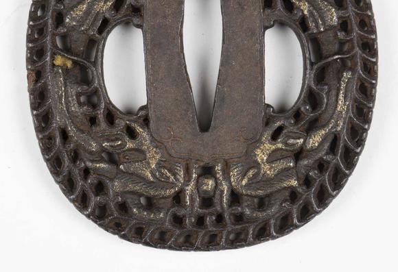 TooveysA fine Japanese oval iron tsuba, Edo period, with intricate