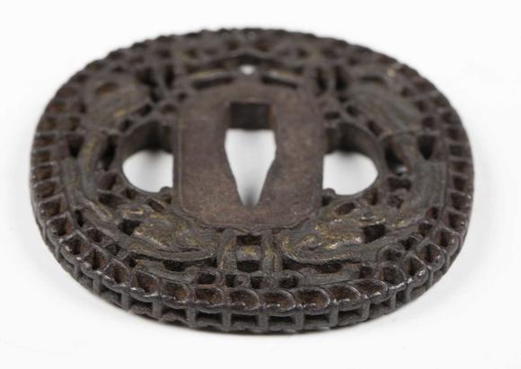 TooveysA fine Japanese oval iron tsuba, Edo period, with intricate