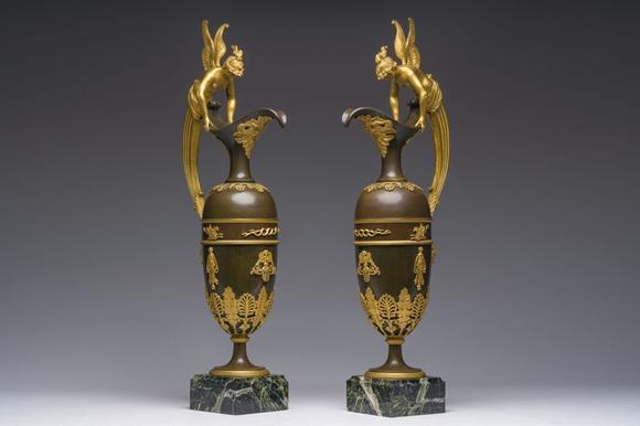 Coronari Auctions BVAn impressive pair of French Empire gilt and patinated bronze ewers on marble bases, attributed to Claude Galle, ca. 1800-1810