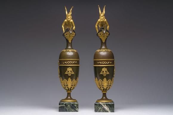 Coronari Auctions BVAn impressive pair of French Empire gilt and patinated bronze ewers on marble bases, attributed to Claude Galle, ca. 1800-1810