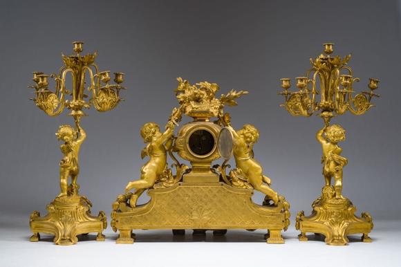 Coronari Auctions BVA fine and exceptional French Napoleon III gilt bronze three-piece clock garniture with putti and floral design, 19th C.