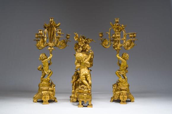 Coronari Auctions BVA fine and exceptional French Napoleon III gilt bronze three-piece clock garniture with putti and floral design, 19th C.