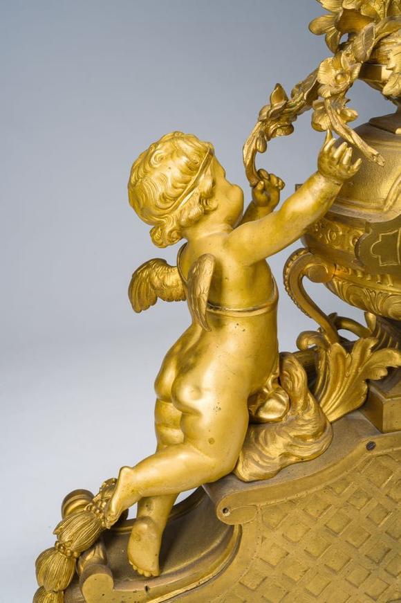 Coronari Auctions BVA fine and exceptional French Napoleon III gilt bronze three-piece clock garniture with putti and floral design, 19th C.