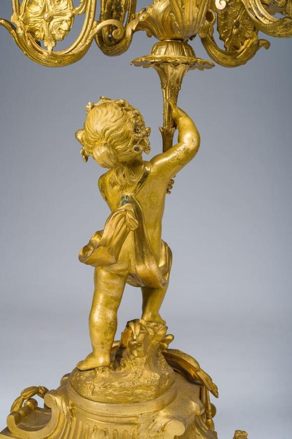 Coronari Auctions BVA fine and exceptional French Napoleon III gilt bronze three-piece clock garniture with putti and floral design, 19th C.
