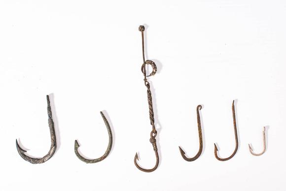 Apollo Art AuctionsCa. 19th century AD. 
A collection of six forged metal fish hooks of varying sizes and forms, wit