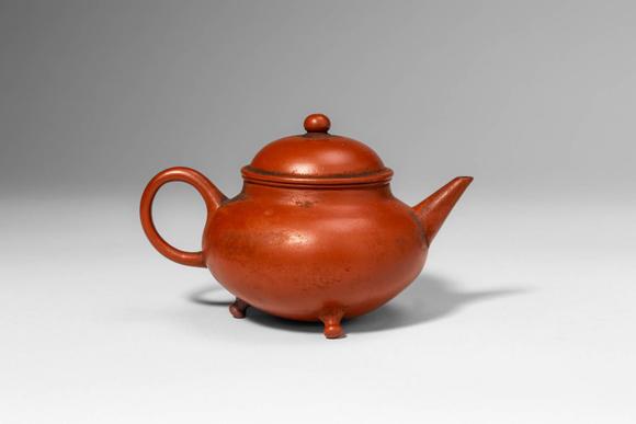 Apollo Art AuctionsCa. 20th century AD. >A Yixing teapot of rounded, compressed globular form, raised on three small