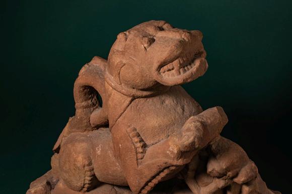 Apollo Art AuctionsCa. 11th - 12th century AD. >
A carved sandstone sculpture depicting a recumbent lion, shown with