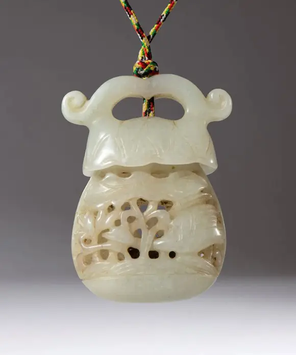 Bertolami Fine ArtA carved and perforated jade pendant container. Used as an essence holder. Inside is a small piece of scented sandalwood. China, Qing Dynasty (1644-1912), late 18th century.