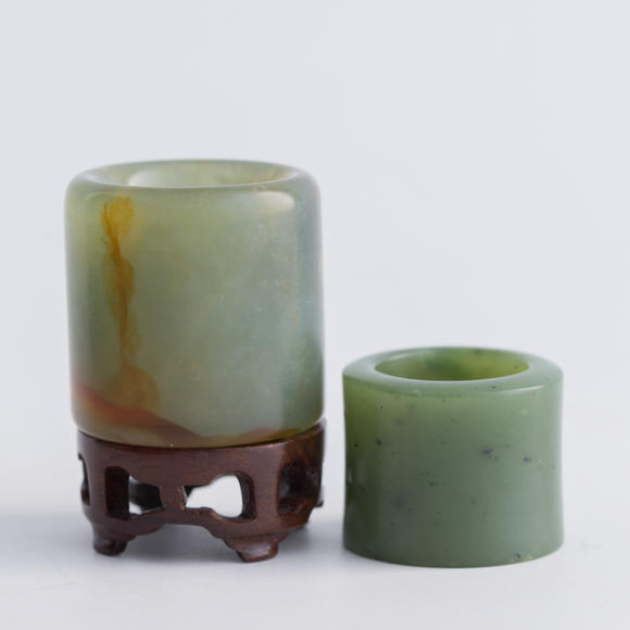 Oakridge Auction Gallery清代 翡翠扳指及碧玉扳指（附木座）  A Chinese jadeite and a spinach jade archer's ring
