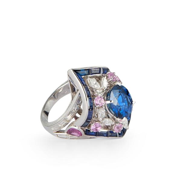 RoseberysA sapphire, diamond and pink sapphire cluster ring, the lozenge shaped cluster with central single oval mixed-cut sapphire in four claw setting, withi