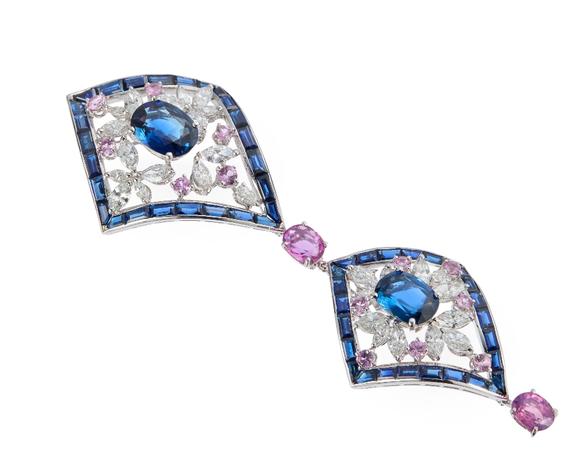 RoseberysA sapphire, diamond and pink sapphire pendant, composed of two lozenge shaped cluster panels, each panel with central single oval mixed-cut sapphire i
