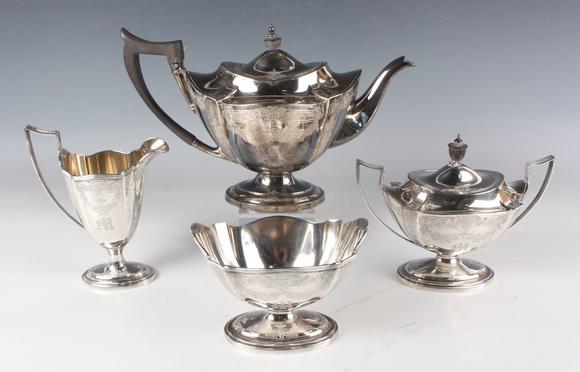 TooveysA George V silver teapot of shaped oval form, engraved with floral a